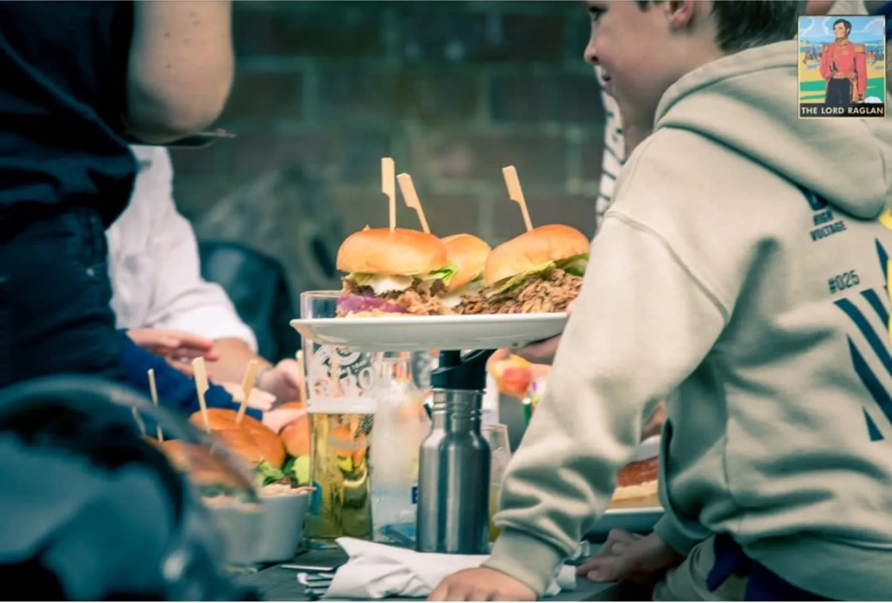 Plates of burgers served in the garden at The Lord Raglan