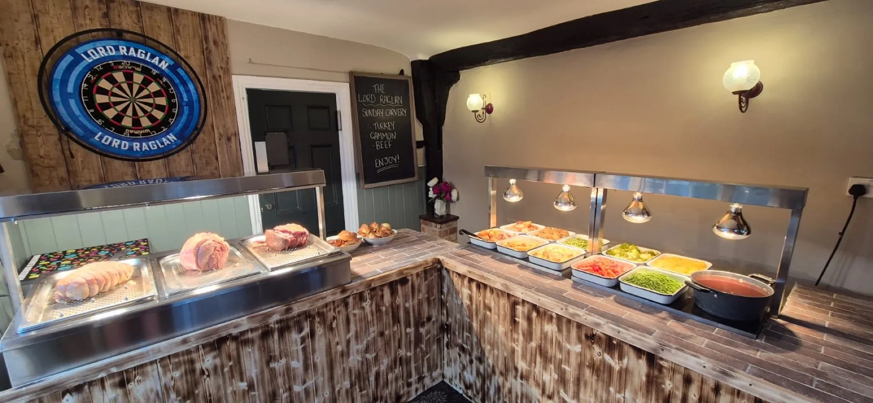 The carvery servery at The Lord Raglan, with joints of meat under the lights