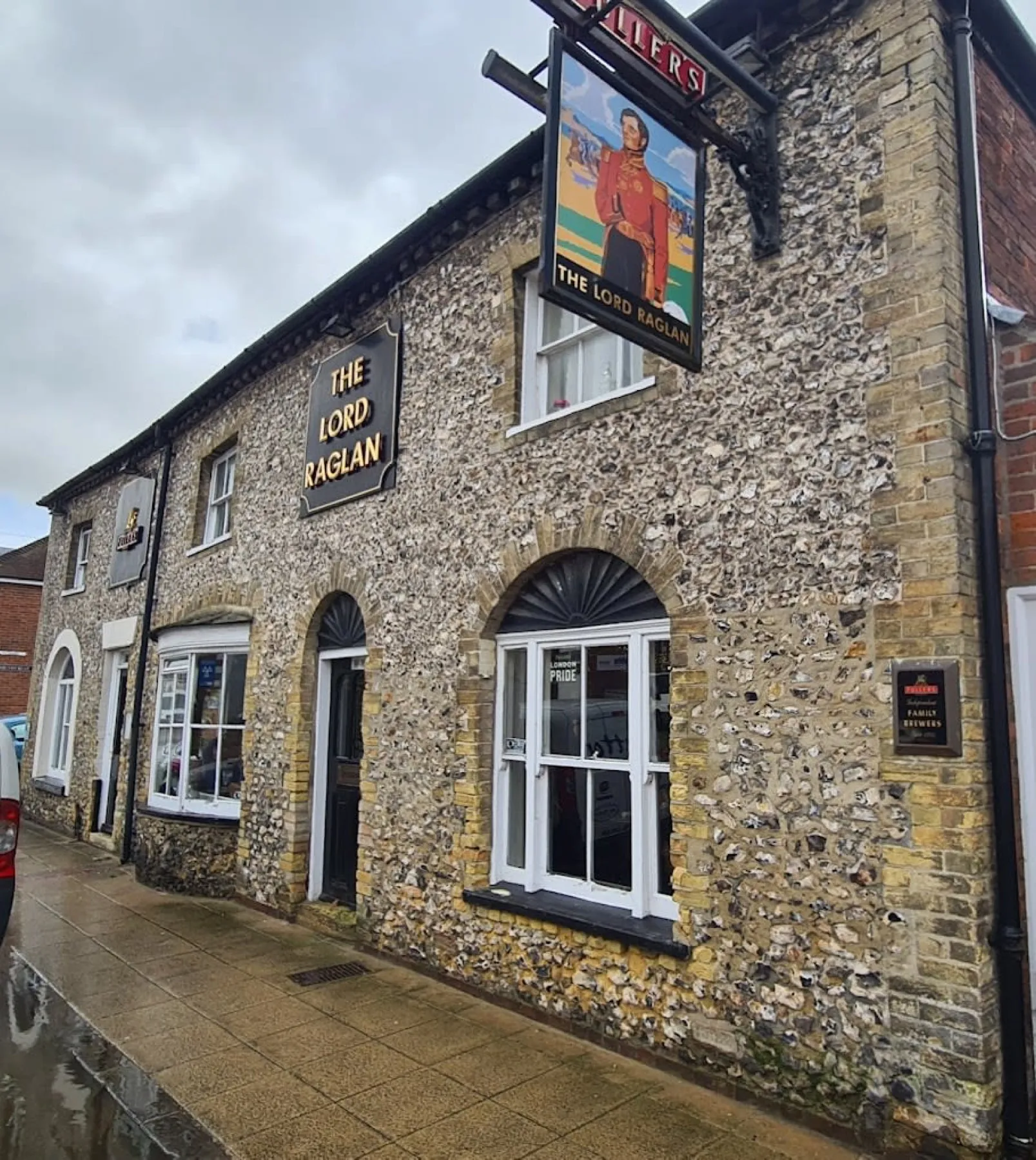 The flint and brick frontage of The Lord Raglan on Queen Street, Emsworth