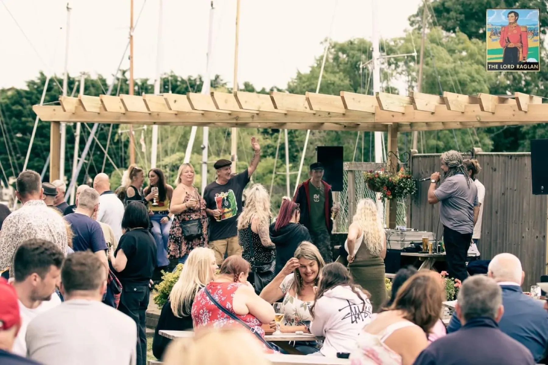 A full waterside garden at The Lord Raglan on a summer afternoon