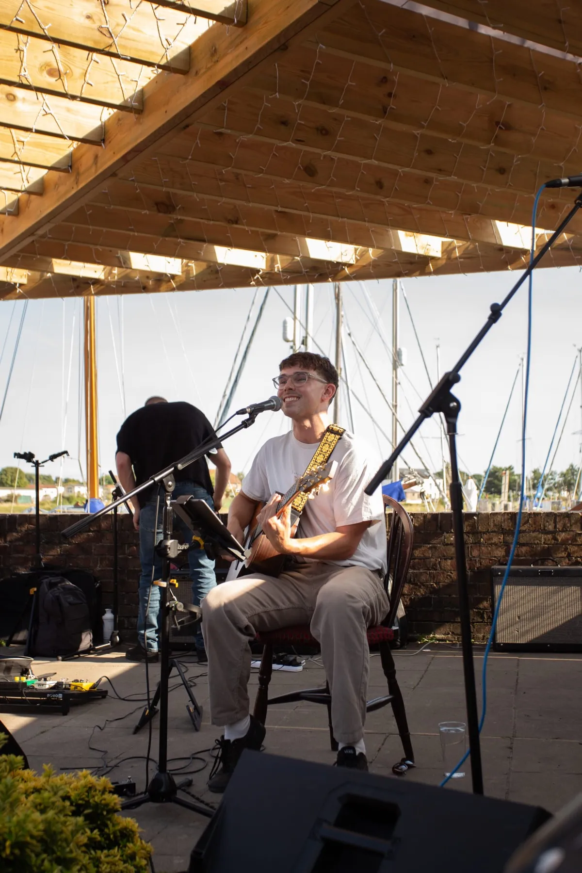 A musician playing live in the garden by the moorings