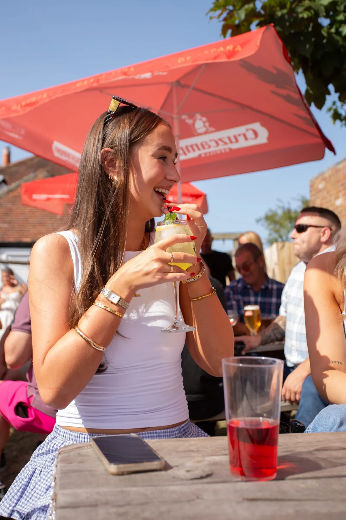 A drink in the sunshine under the parasols at The Lord Raglan